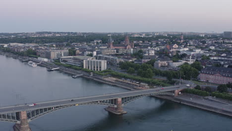 aerial drone view of mainz with dom, castle, theodor heuss bridge and cityscape at sunset – rhine river, germany
