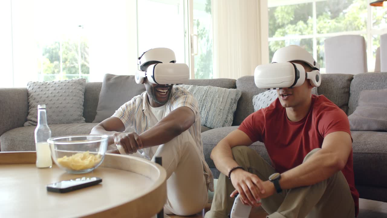 Uomini afroamericani e ispanici giocano a canottaggio in VR a casa, togliendosi le cuffie alla fine del gioco.