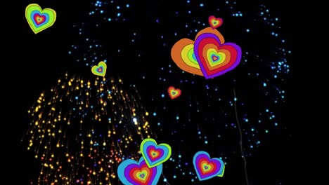 animación de corazones arco iris sobre fuegos artificiales en fondo negro.