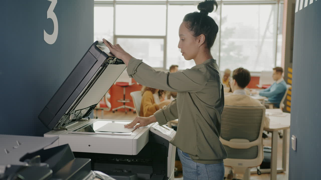 Woman Printing Documents in a Modern Office
