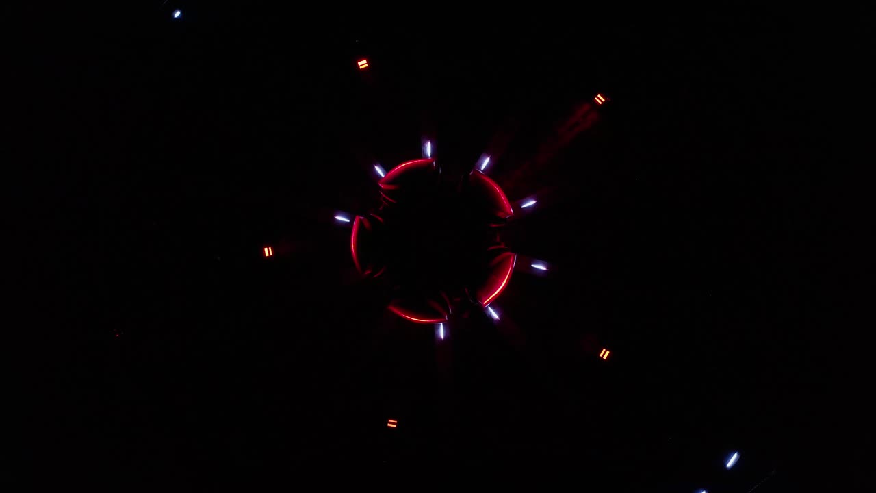 Aerial ascending drone footage of an abstract and colourful circle led lights show placed in a fountain in Bratislava, Slovakia