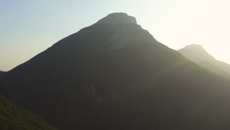 Aerial-sunset-shot-revaling-Moniga-del-Garda-from-high-above-the-the-mountains