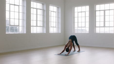 beautiful yoga woman practicing downward-facing dog pose enjoying fitness lifestyle exercising in studio stretching flexible body training early morning meditation on exercise mat