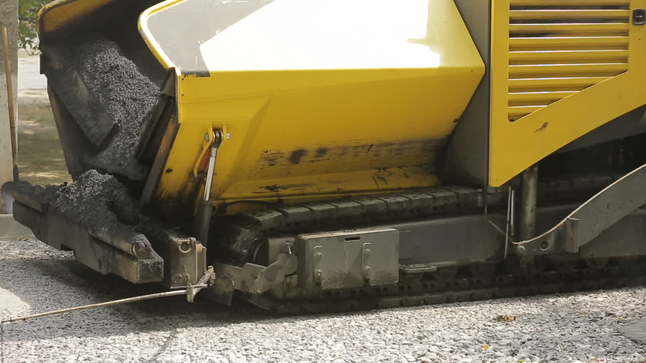 Road Roller At Road Construction Site. Pneumatic steam road rollers machines compacting fresh asphalt