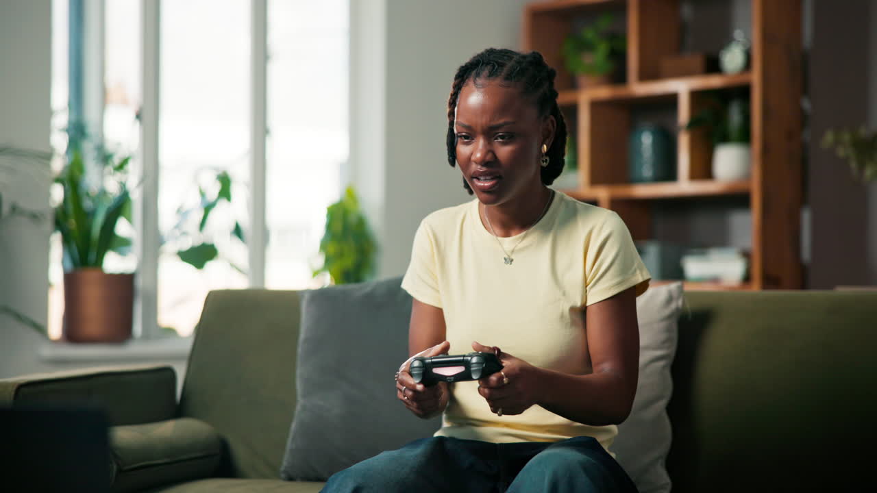 Woman playing video games at home