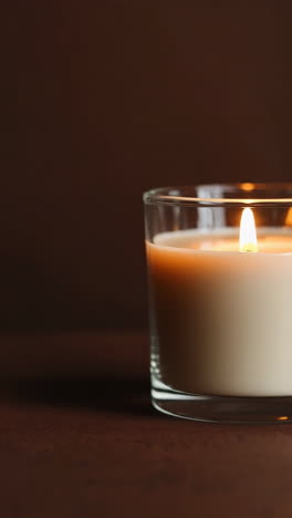 warm glow of a lit candle in a glass jar