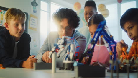 students and teacher working on robotics project in classroom