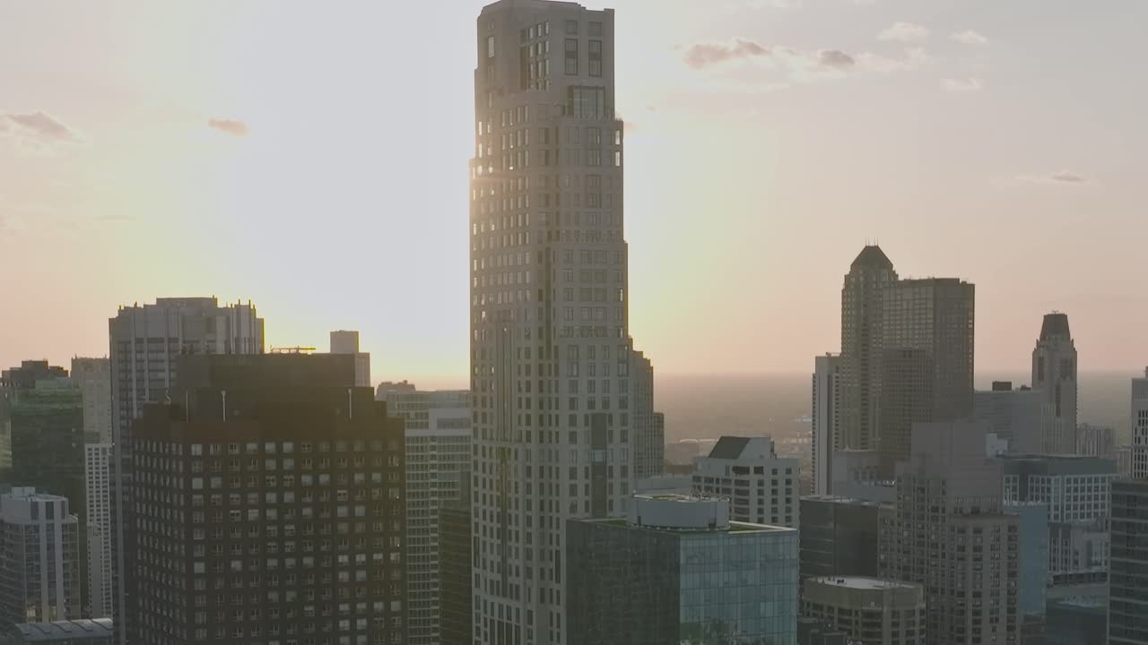 View of Chicago skyline with sun setting over the city buildings