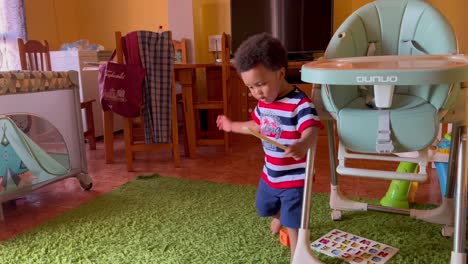 two year old african child spinning funny on his heels and a little dizzy