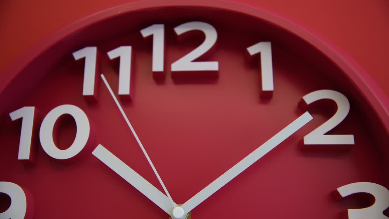 Red wall clock on red background