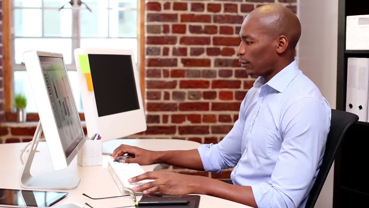 Casual businessman working at desk with computer