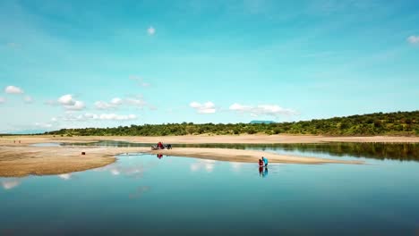 people at the lake magadi enjoying and taking a refreshing bath on a sunny day in kenyan rift valley, kenya