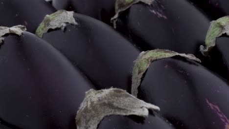 macro shooting. heap of mini purple eggplants. rotating on the turntable. isolated on the white background. close-up.