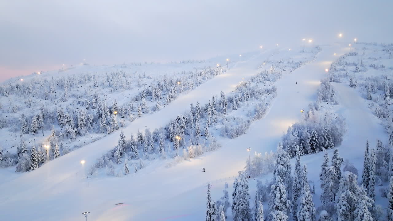Aerial view in front of the slopes of Sallatunturi, winter sunrise in Finland
