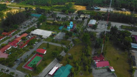 Cinematic-Drone-Footage-of-Palm-Oil-Mill-Effluent-residential-consists-of-buildings,-homes,-main-road-and-infrastructure-surrounded-by-palm-oil-trees-deforestation-located-in-Indonesia-in-full-HD