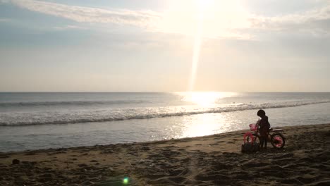 Niño-with-a-Bicycle-on-a-Beach