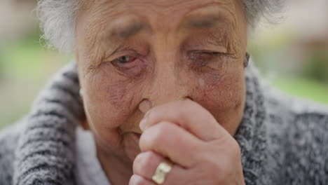 close up portrait of sad elderly woman crying looking lonely depressed tired senior outdoors