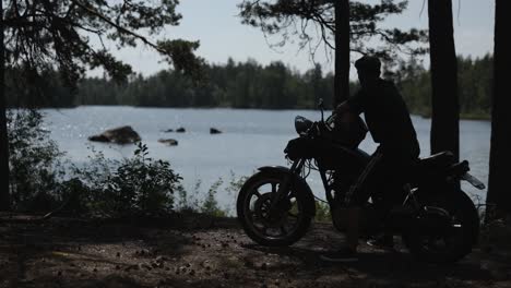 man on motorcycle enjoying lake view