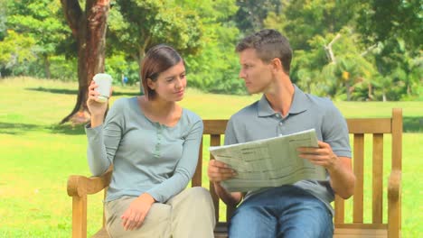 young couple reading a newspaper