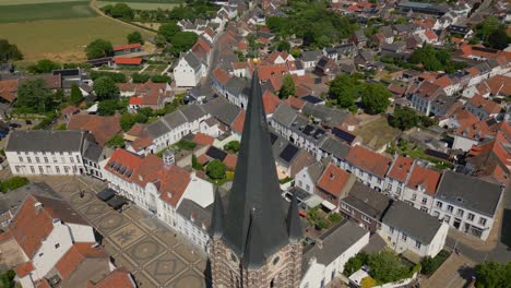 Parallax-shot-with-drone-of-the-Limburg-Abbes-Church,-Wijngaard-in-thorn-in-the-municipality-of-Maasgouw-with-a-view-of-the-Dutch-architecture-with-historic-buildings