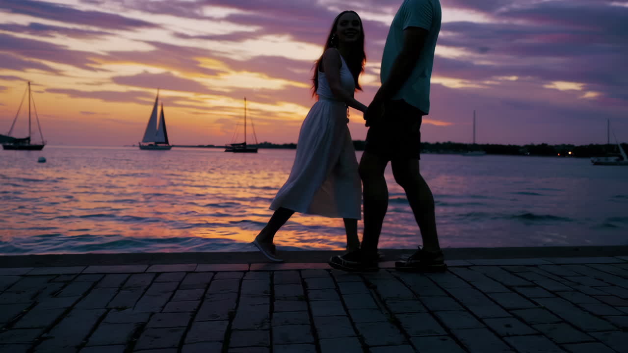 Couple enjoying a romantic sunset walk by the sea