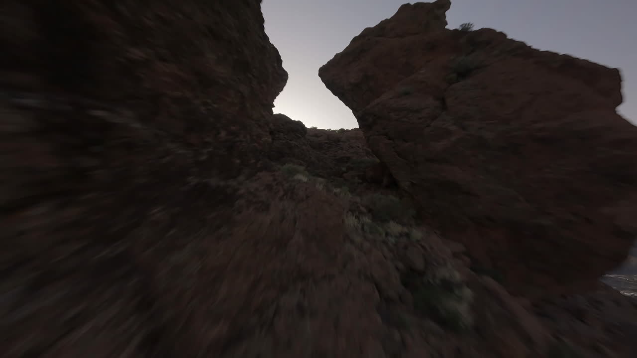 fpv freestyle volando a través de la brecha rocosa de la montaña roque nublo y bajando por terrenos extremos, gran canaria