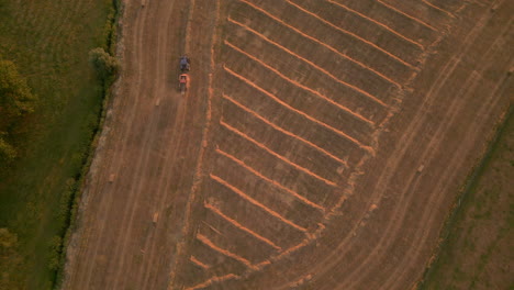 top down view of a tractor on a field during sunset on the countryside of belgium