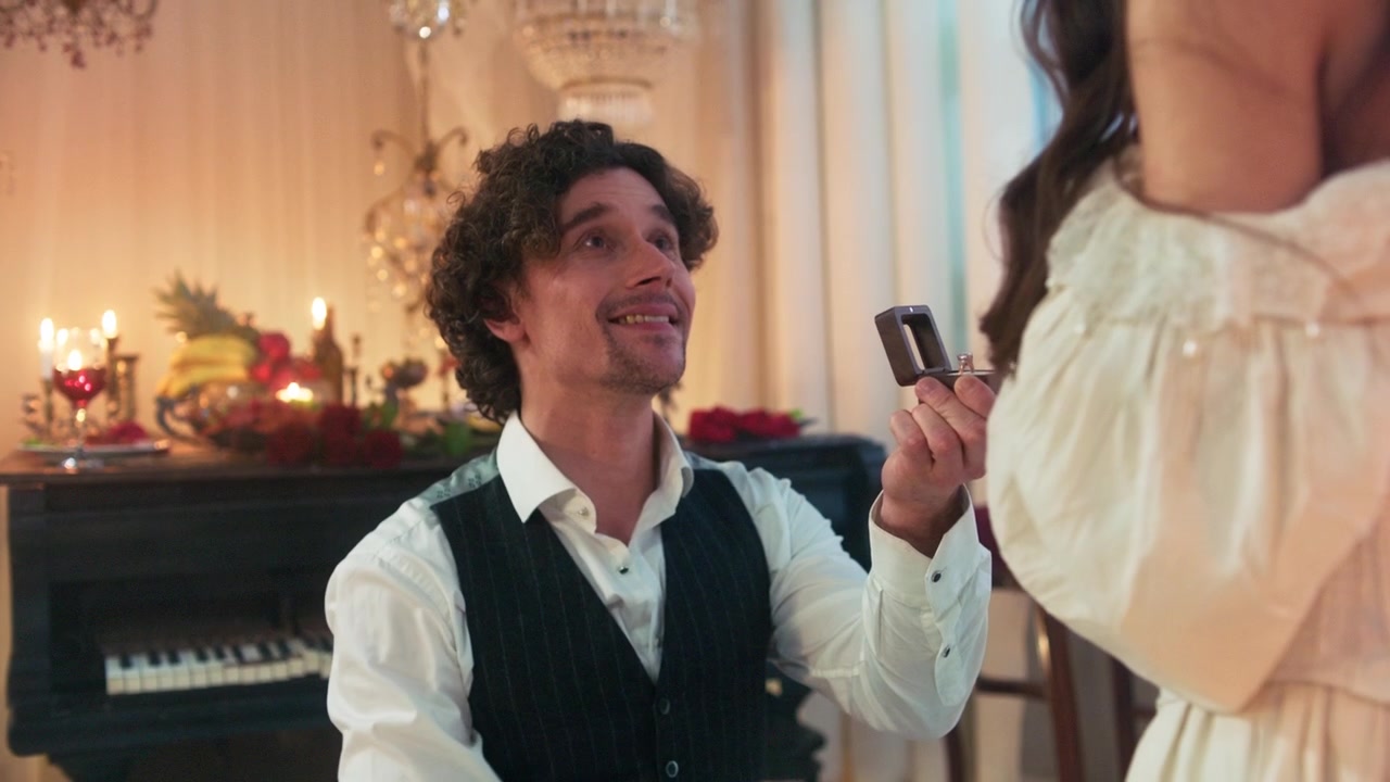 Man Proposes to Woman with Engagement Ring in Elegant Room