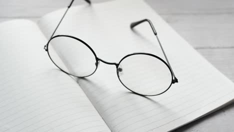 round glasses on an open notebook