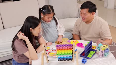 A family enjoys playing educational games together, fostering learning and connection in a cozy home setting