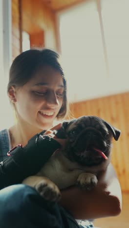 woman and her pug puppy