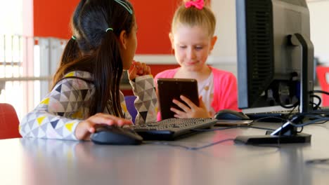 schoolgirls studying on computer in school 4k