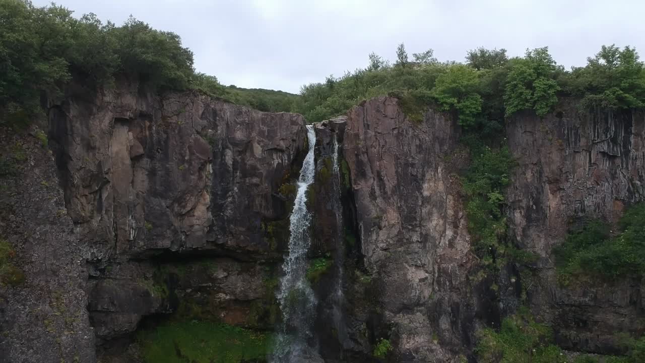 aerial shot of Powerful and beautiful waterfall in Iceland, wild green lush nature, nature documentary concept cinematic drone footage