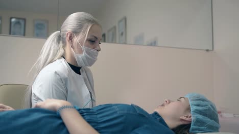 brow master consults girl on eyebrows tattooing in salon