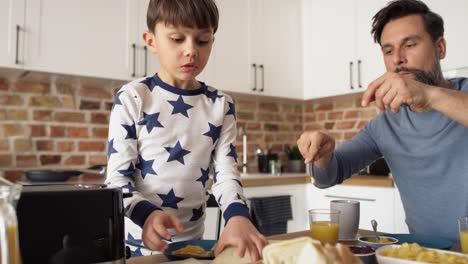 video of son and father having breakfast in the morning