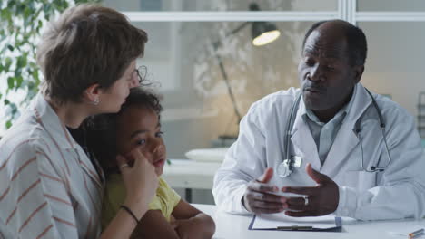 doctor consulting with a mother and child