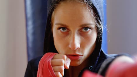 female boxer practicing boxing in fitness studio 4k