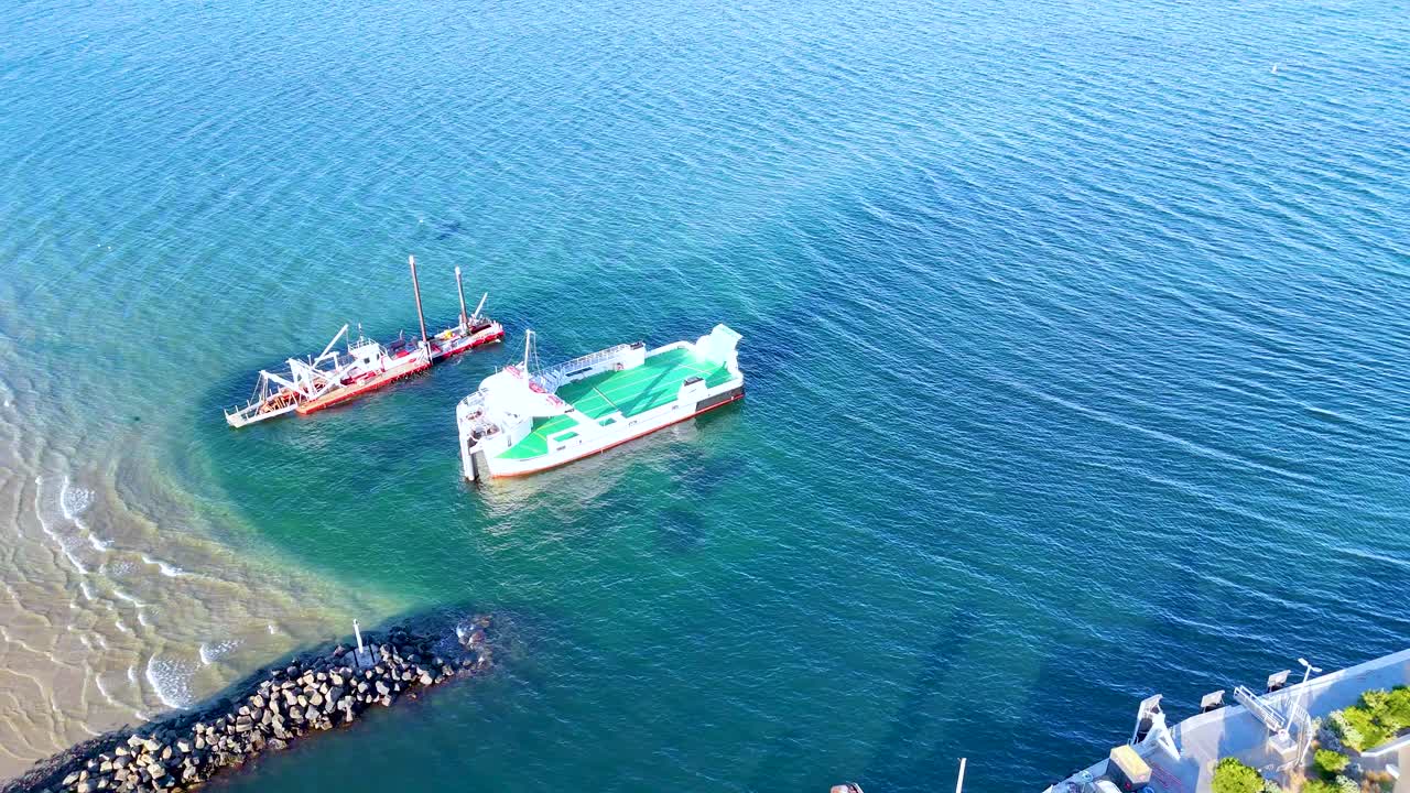 Drone captures two ferries navigating clear waters near Bellarine Peninsula, Victoria. Bright daylight enhances the serene coastal scene