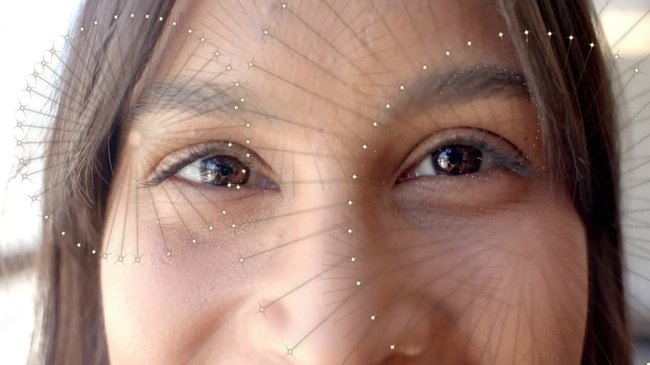 Adult female gazing while camera starting face scan, AR overlay radiating across face for tech demo