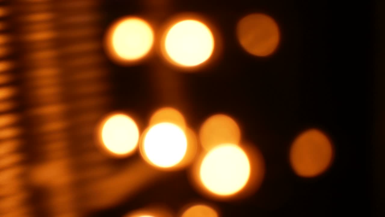 Blurred yellow lights on a black background.