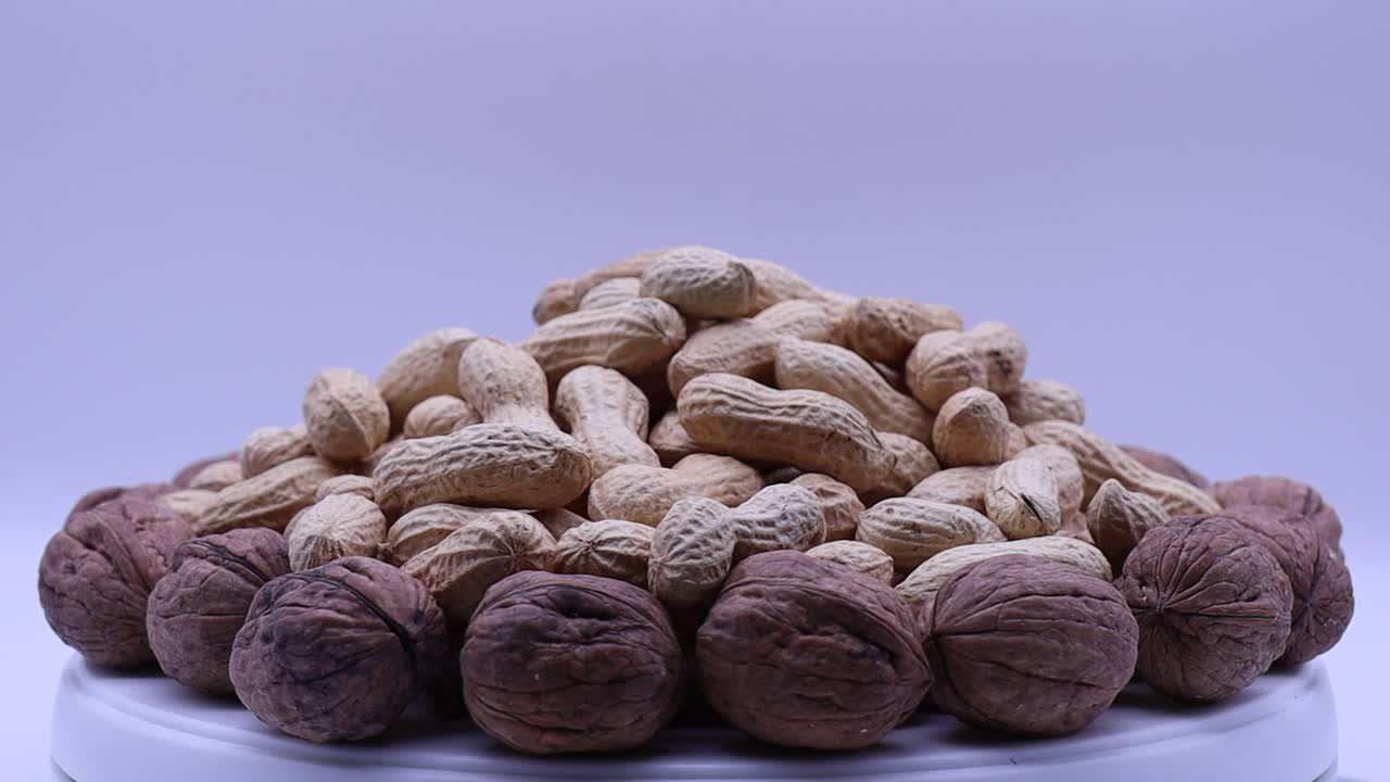 Walnuts and peanuts rotating on a turntable