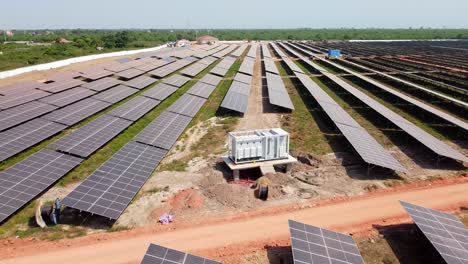 installation and cabling of medium voltage industrial solar inverter at solar farm aerial reverse view