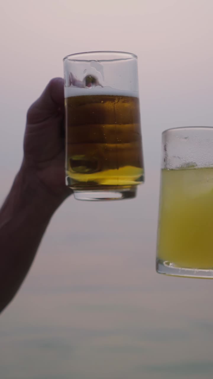 People enjoying drinks by the ocean