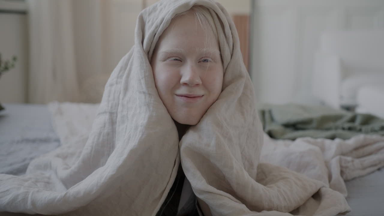 Child Hiding Under Blanket