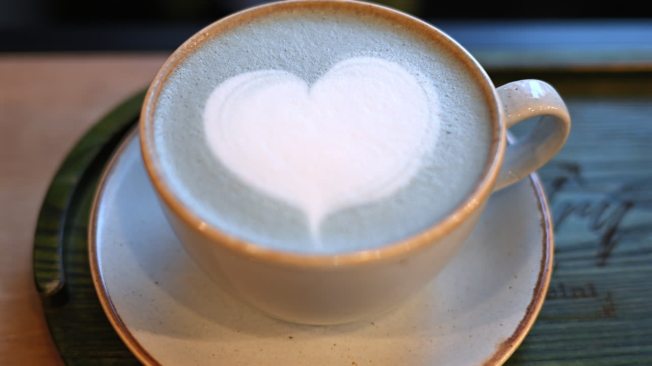 Top down shot of foam latte art on blue matcha drink