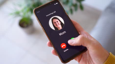 man receiving call from his mom - incoming call from mom. - closeup shot