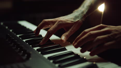 musician playing keyboard in recording studio