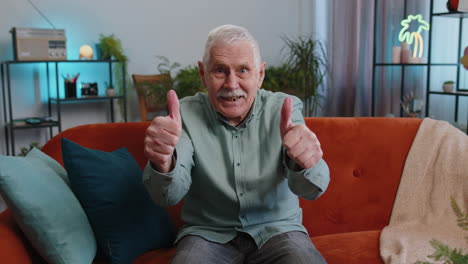 Happy-grandfather-man-looking-approvingly-at-camera-showing-thumbs-up,-like-positive-sign,-good-news