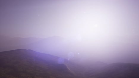 aerial green hills landscape in fog