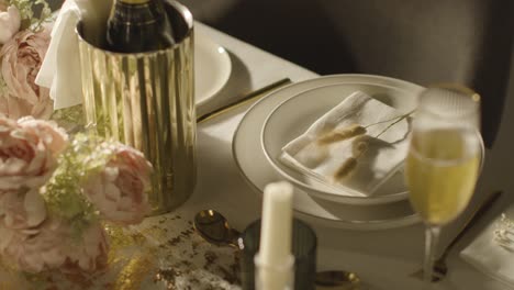 table set for meal at wedding reception with champagne in ice bucket 1